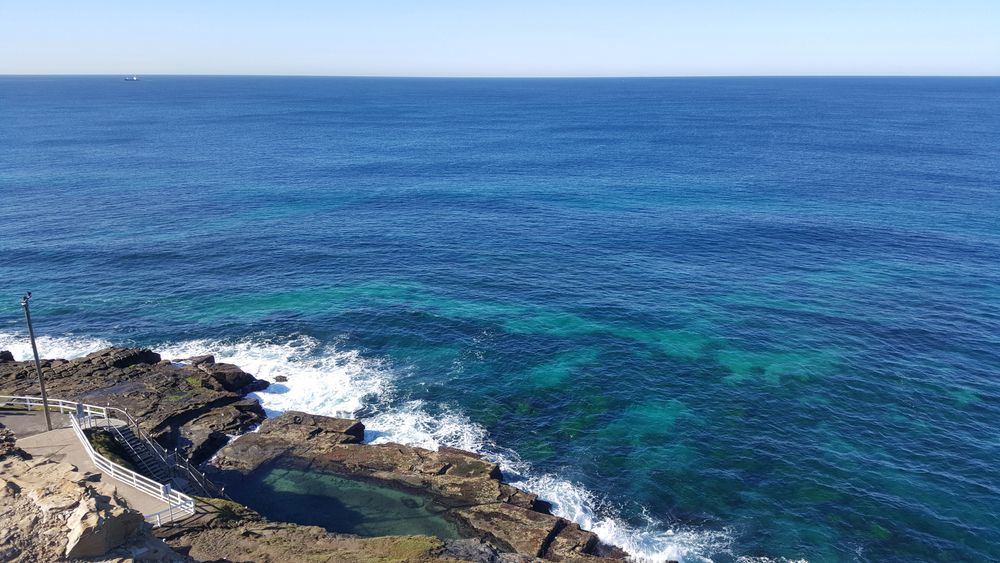 A View of the Ocean From a Cliff With Waves Crashing on the Rocks — Roof Restoration Masters In Morisset, NSW