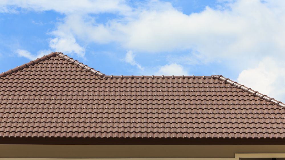 A Brown Tiled Roof of a House — Roof Restoration Masters In Belmont, NSW