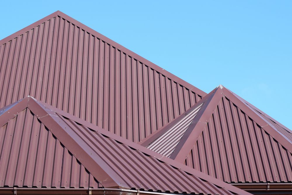 A Brown Roof With a Blue Sky in the Background — Roof Restoration Masters In Thornton, NSW