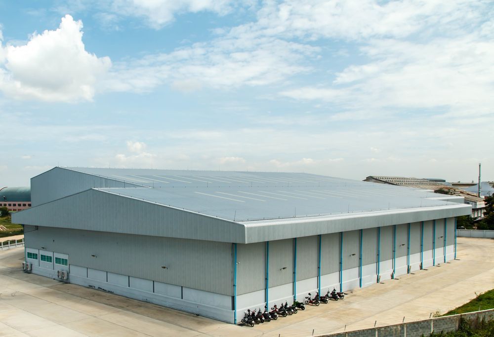 An Aerial View of a Large Warehouse — Roof Restoration Masters In Cameron Park, NSW
