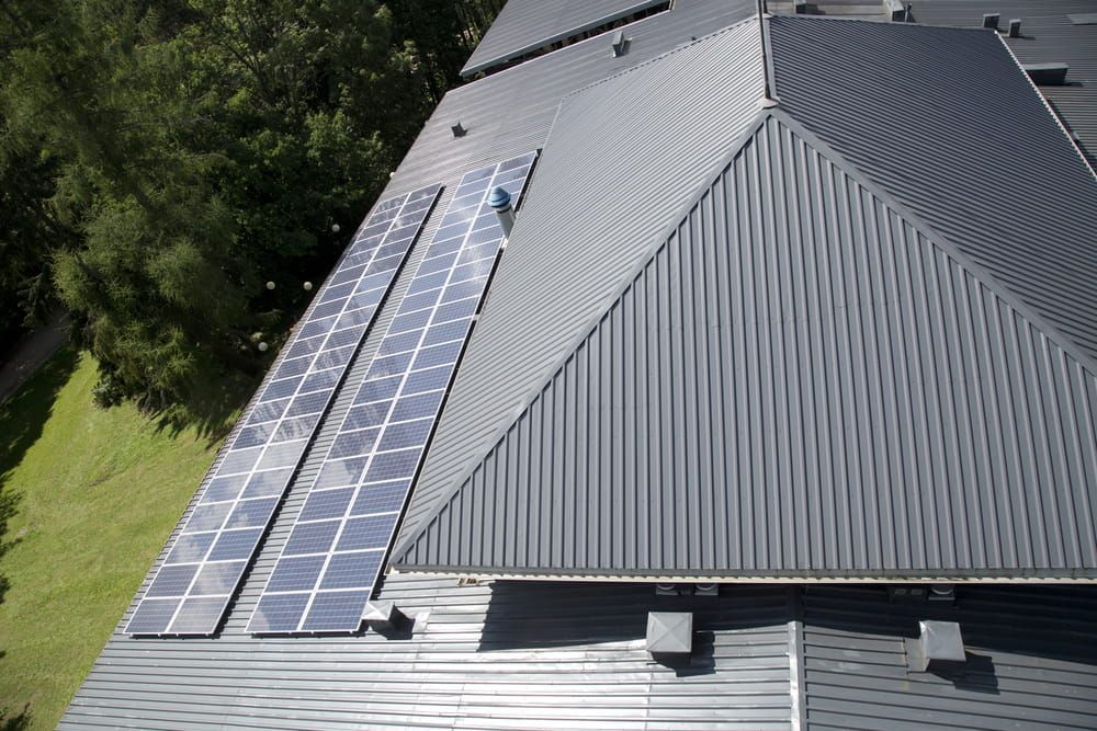 Aerial View Of A Roof With Solar Panels On It — Roof Restoration Masters in Morisset, NSW