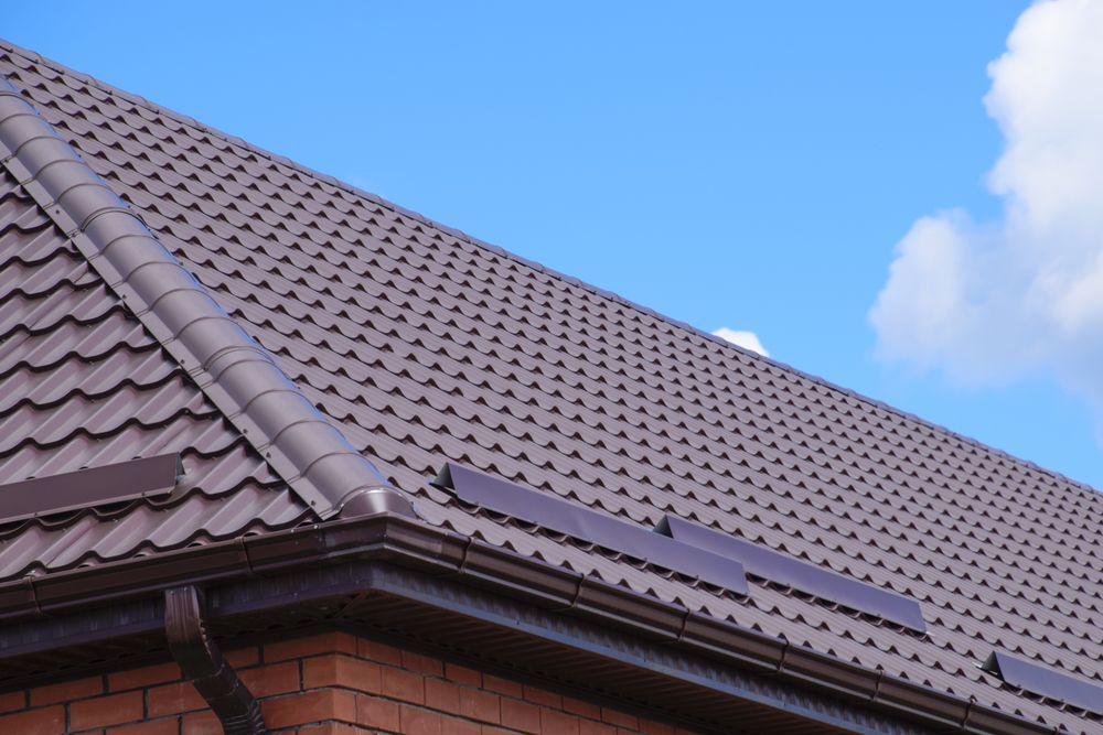 A Brown Roof With a Blue Sky in the Background — Roof Restoration Masters In Morisset, NSW