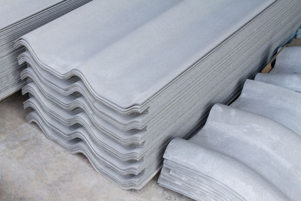 A Stack of Gray Corrugated Roofing Sheets on the Ground — Roof Restoration Masters In Thornton, NSW