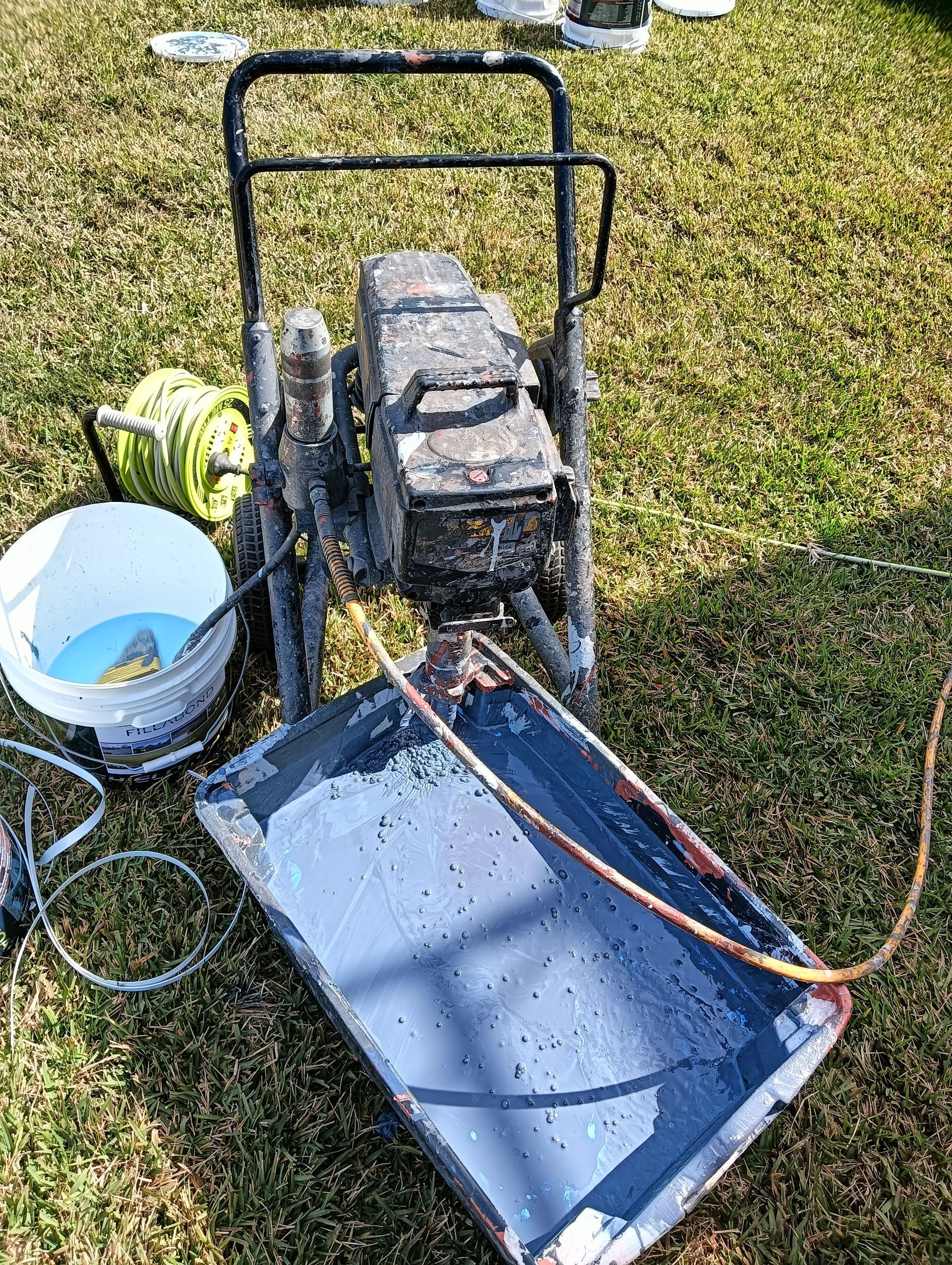 A Man is Using a High Pressure Washer to Clean a Roof — Roof Restoration Masters In Morisset Park, NSW