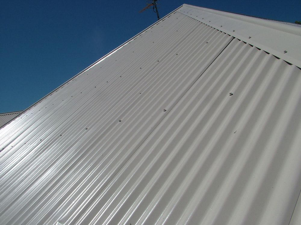 White Roof With a Blue Sky in the Background — Roof Restoration Masters In Morisset Park, NSW