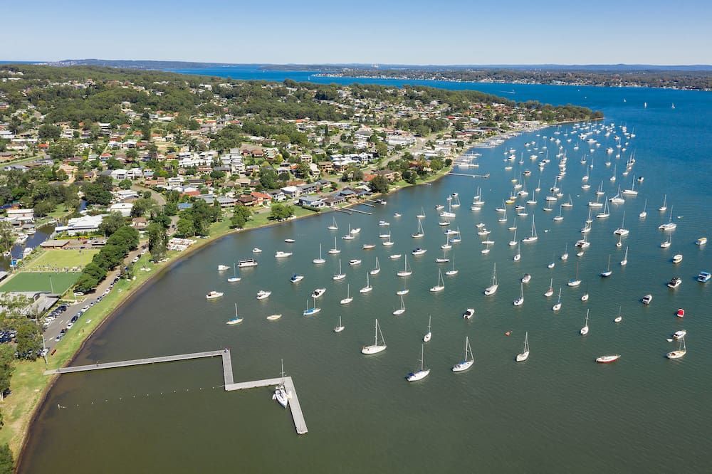 An Aerial View of a Large Body of Water Filled With Boats — Roof Restoration Masters In Valentine, NSW