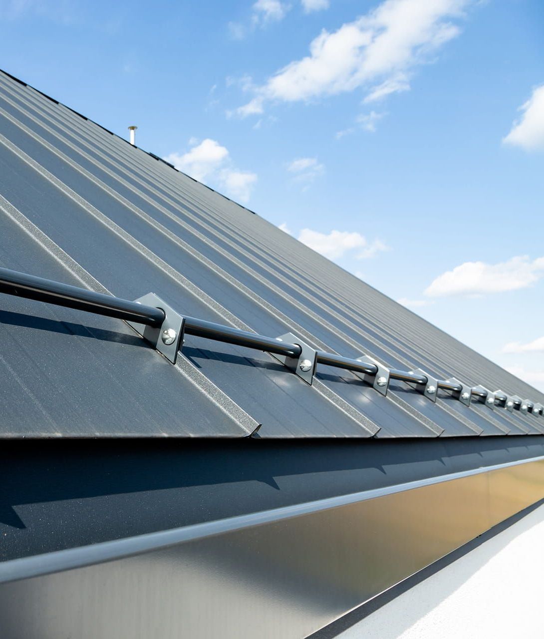 A Close Up of a Roof With Snow Guards on It — Roof Restoration Masters In Raymond Terrace, NSW