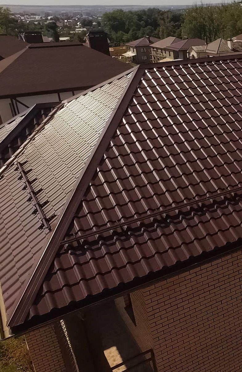 An Aerial View of a House With a Brown Tiled Roof — Roof Restoration Masters In Belmont, NSW