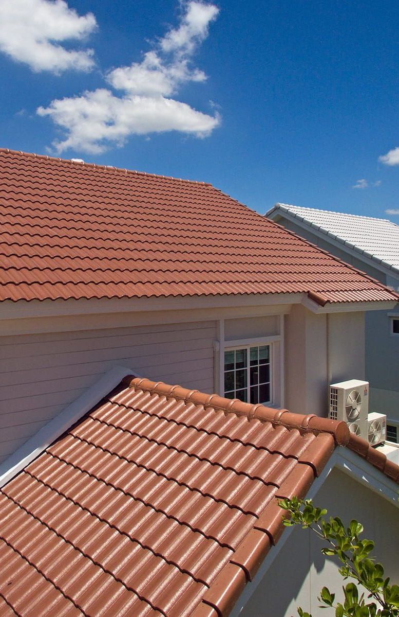 A House With a Red Tiled Roof and a Balcony — Roof Restoration Masters In Mannering Park, NSW