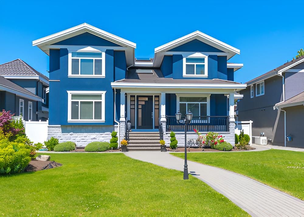 A Large Blue And White House With A Large Lawn — Angel Conveyancing In Larrakeyah, NT