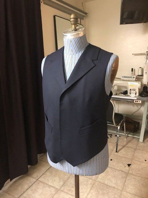 Navy vest on a mannequin in a tailor's workshop.