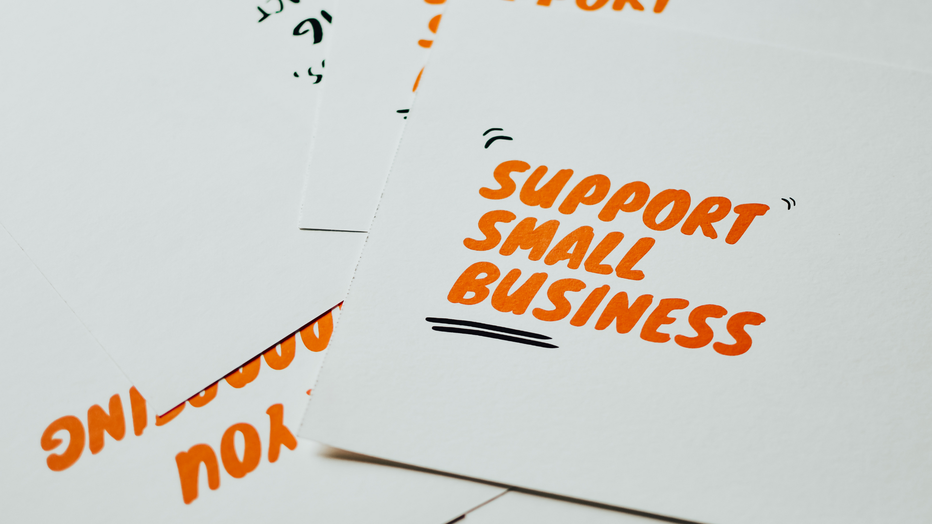 A piece of paper with the words `` support small business '' written on it.