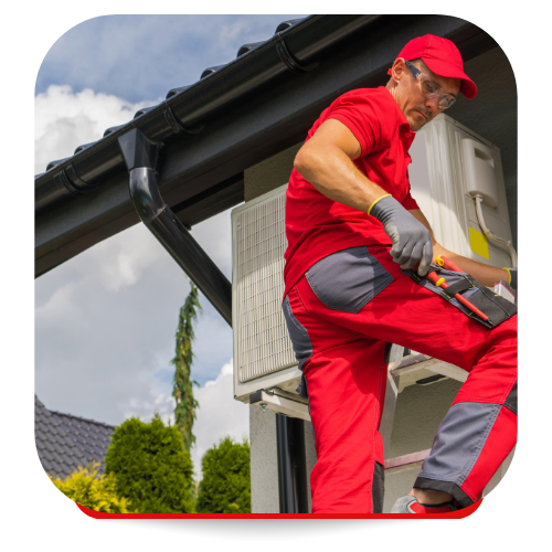 HVAC technician in red jumpsuit works on an outdoor unit near a gutter under a cloudy sky.