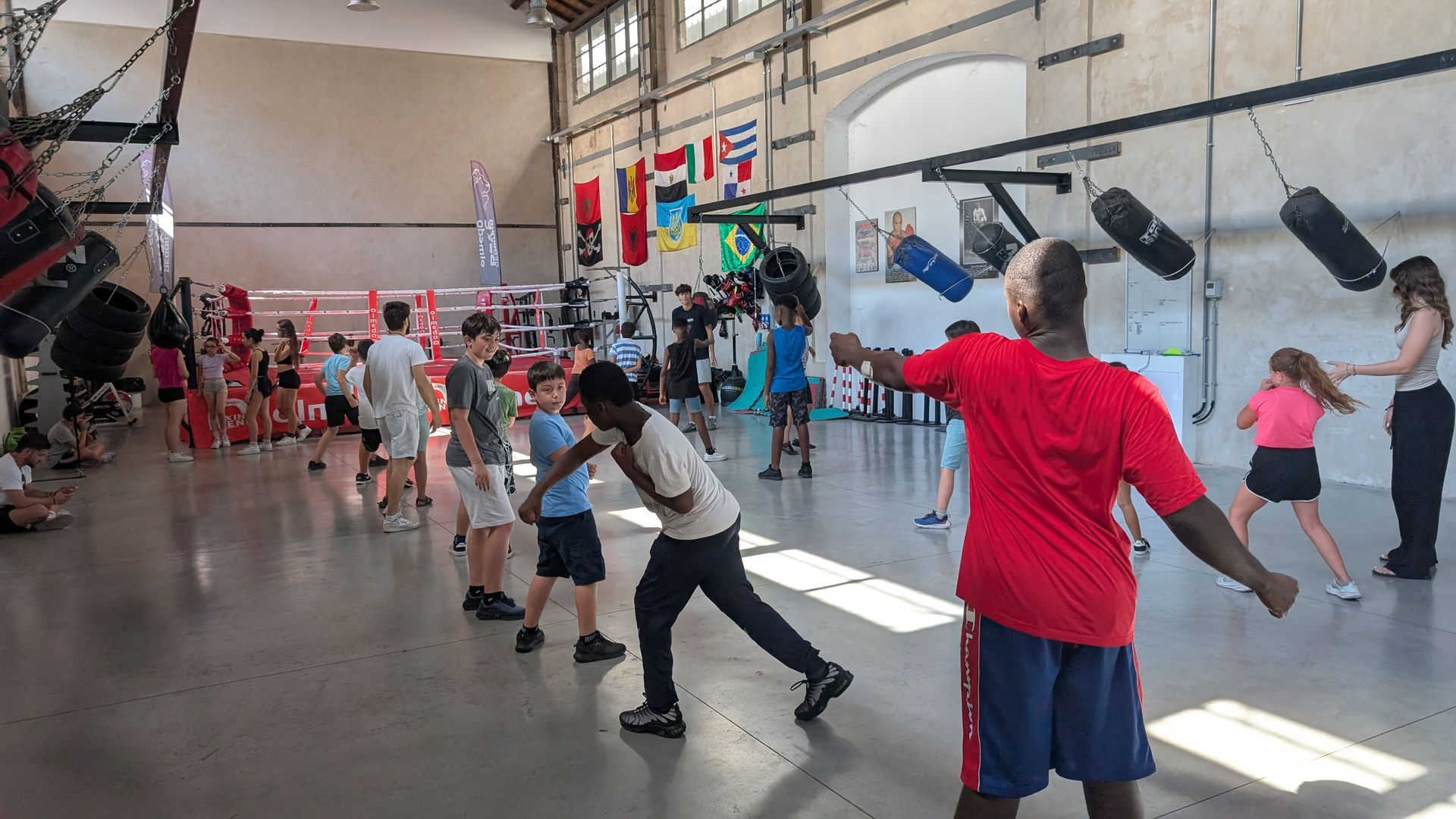 Bambini e bambine che seguono una lezione di boxe 