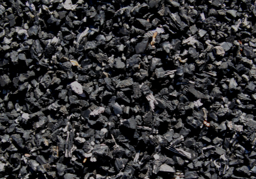 Close-up of dark gray crushed stones or gravel filling the frame.