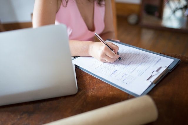 two people sitting at a table for a tenant screening interview