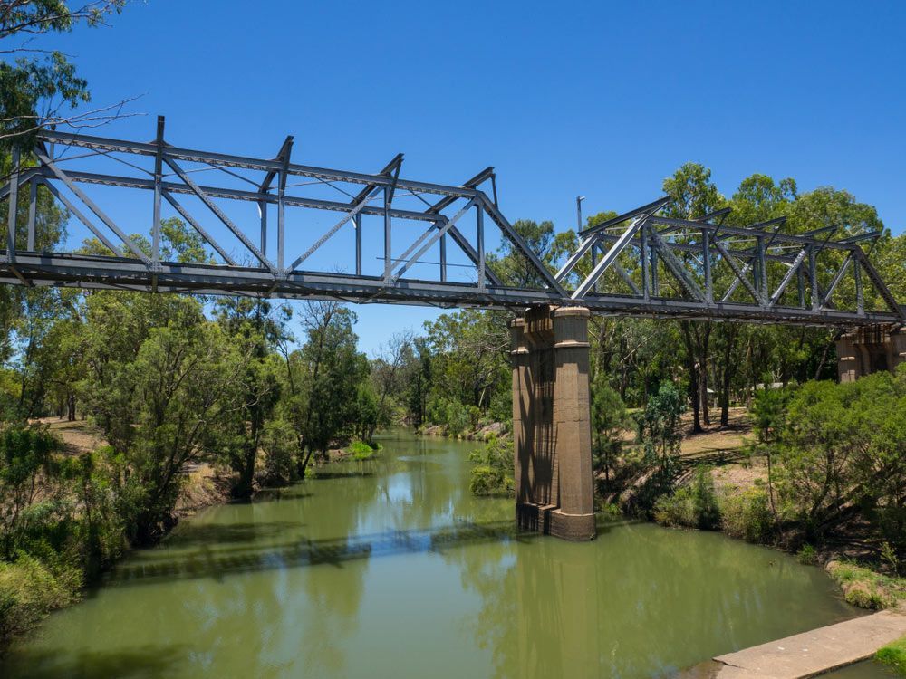 A Bridge Over A River With Trees On Both Sides — Professional Security Guards in Emerald, QLD