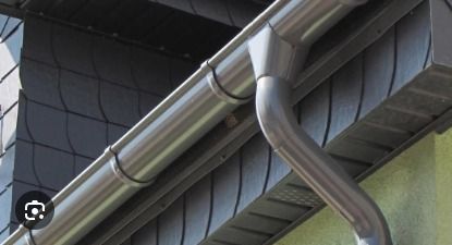 Un primer plano de una canaleta en el costado de un edificio.