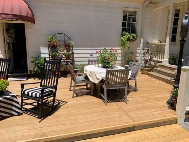 A wooden deck with a table and chairs on it