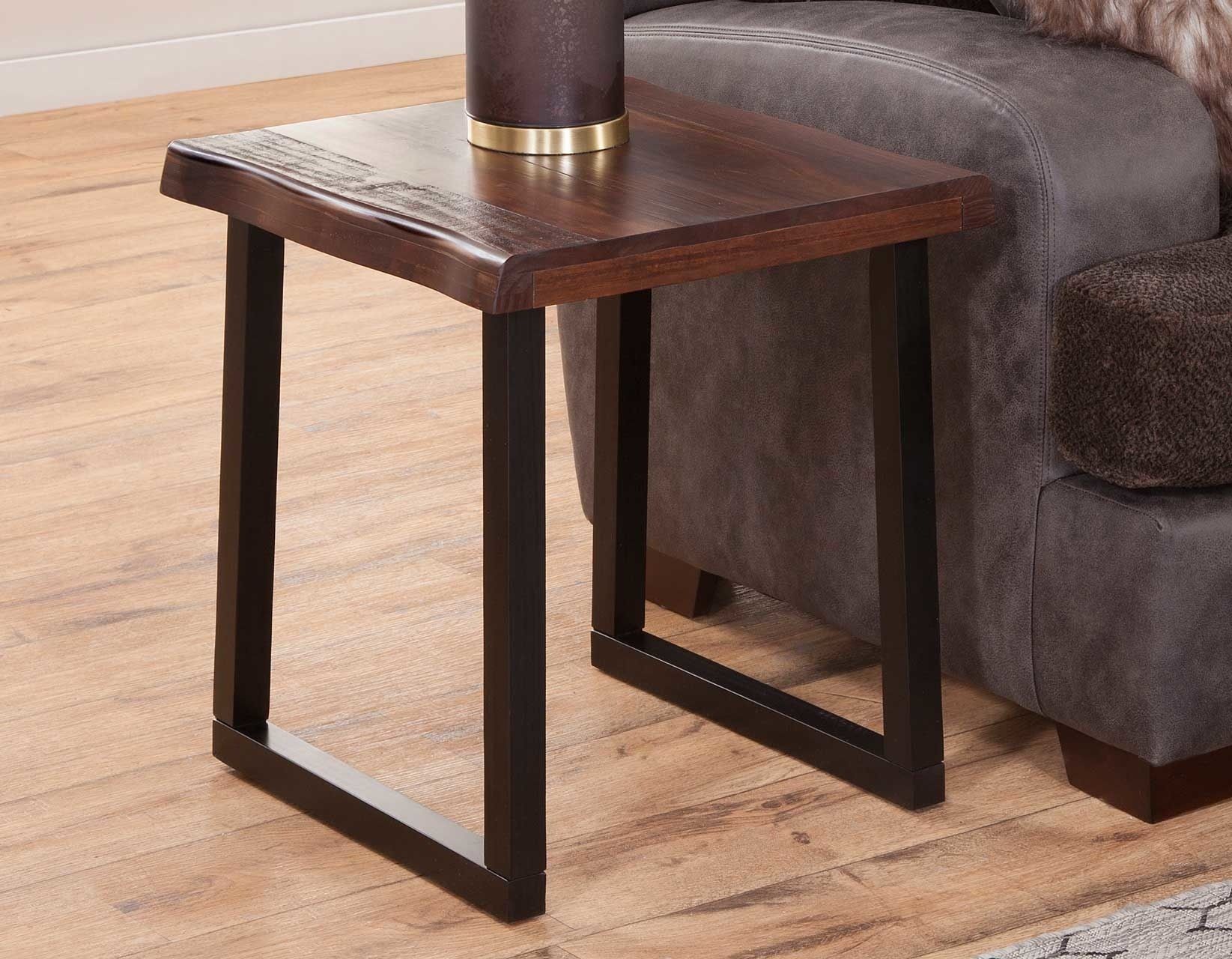 A small wooden table is sitting next to a couch in a living room.