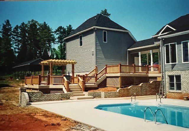 A large house with a large swimming pool in front of it