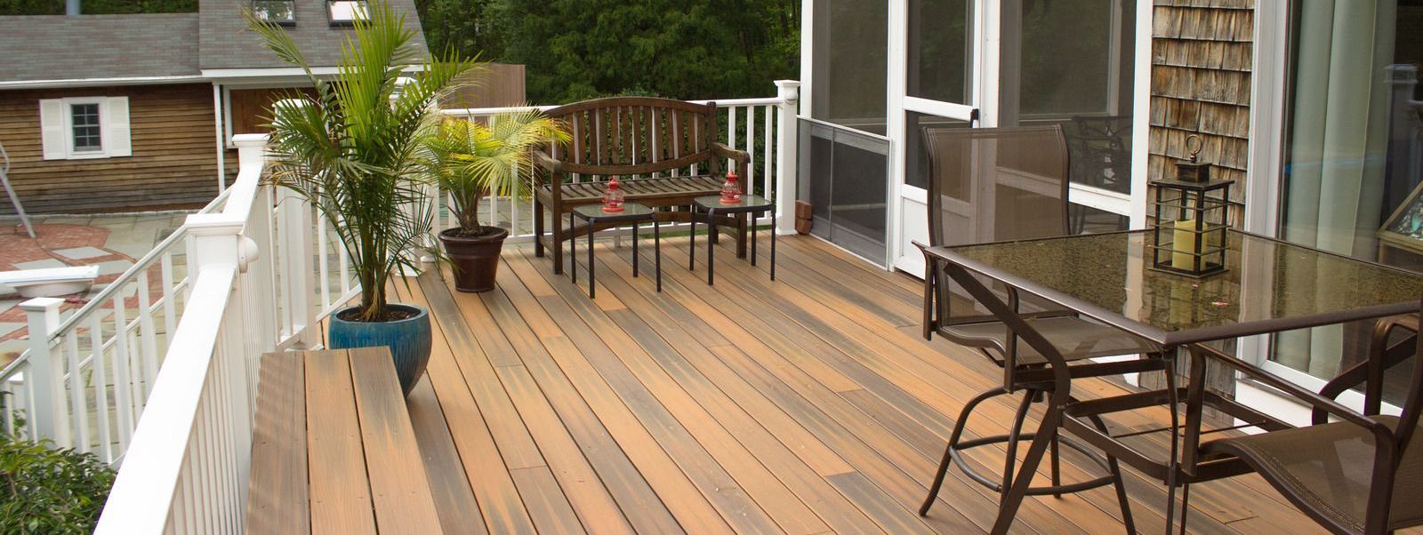 A wooden deck with a table and chairs on it