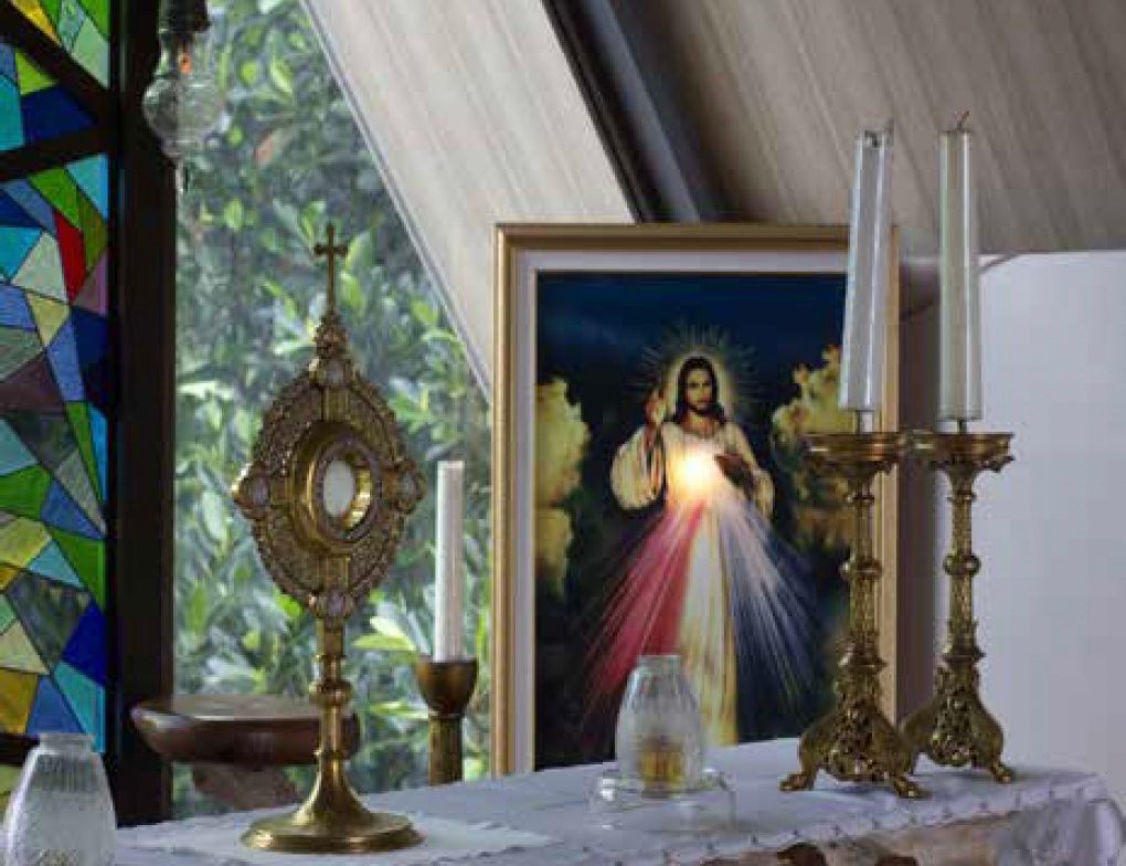A stained glass window with a picture of jesus on it