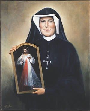 A nun is holding a picture of jesus in a frame