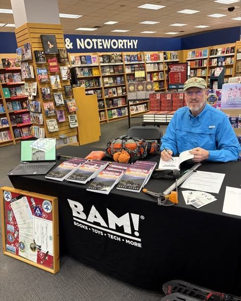 Man signing books at a