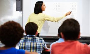 Teacher writing on interactive whiteboard