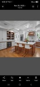 Bright modern kitchen with white cabinets, island seating, wood floors, and a farmhouse sink