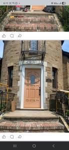 Brick townhouse entrance with tan door, black iron railings, and a small balcony above the doorway