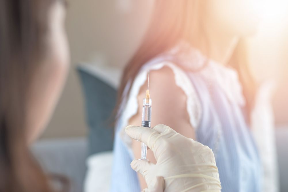 Gloved Hand Holding a Syringe Near a Patient in a Clinical Setting — HealthHub Taree in Taree, NSW