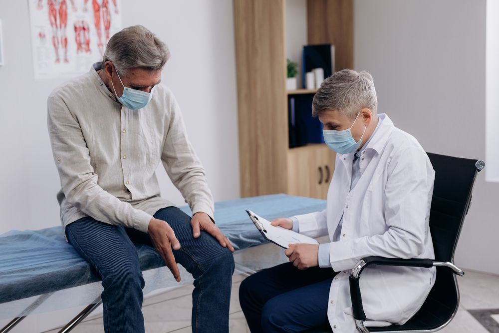Doctor Consulting a Seated Patient in a Clinic — HealthHub Taree in Taree, NSW