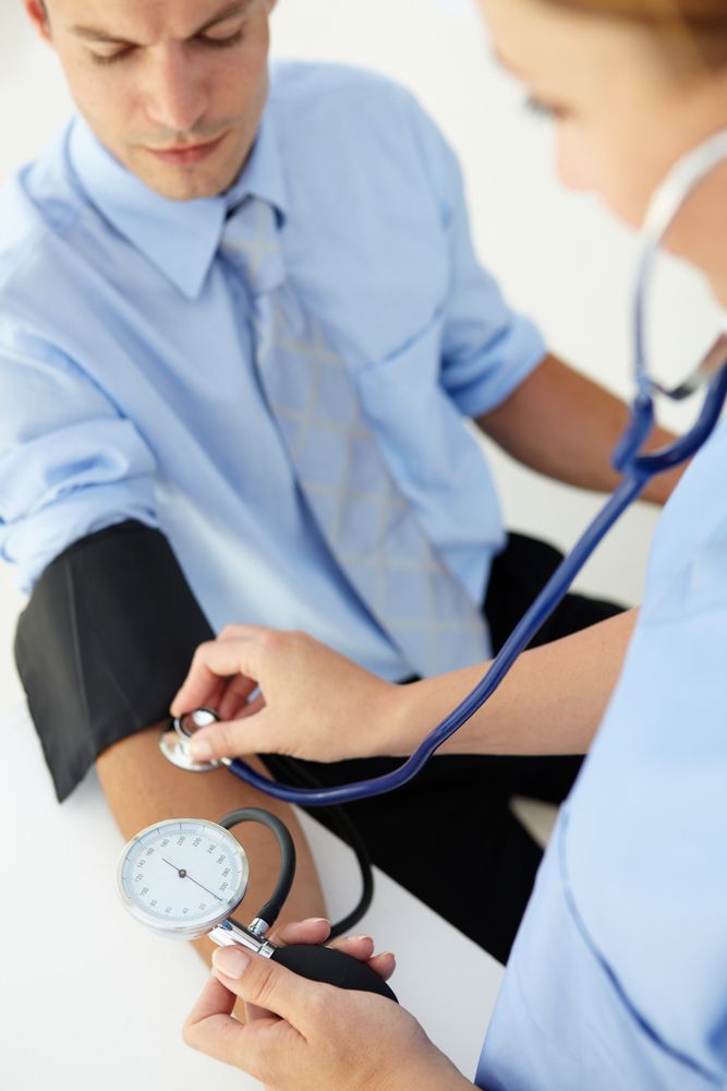 Doctor Taking Blood Pressure With a Cuff and Stethoscope on a Patient — HealthHub Taree in Taree, NSW