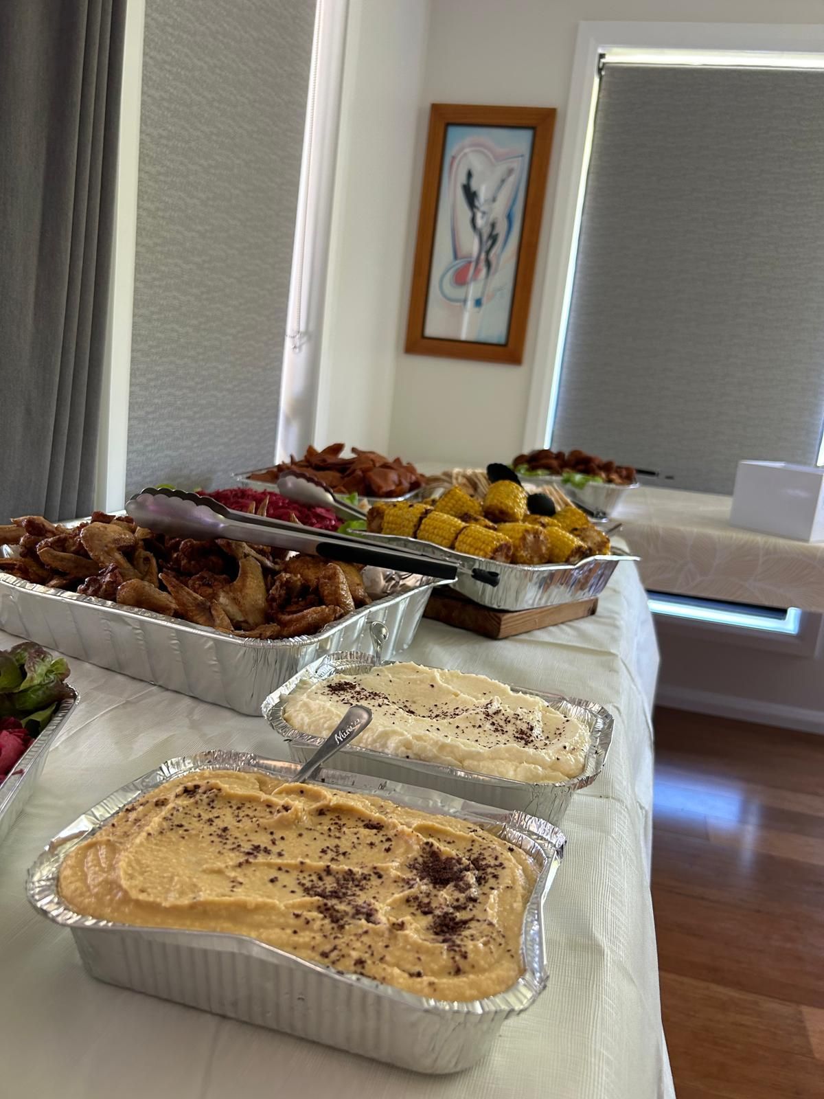 Buffet table with various dishes: hummus, chicken, roasted vegetables. — The Habibiz Catering In Wingham, NSW
