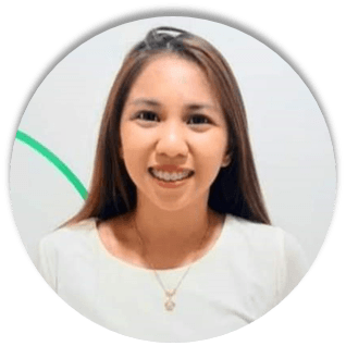 A woman wearing a white shirt and a necklace is smiling in a circle.