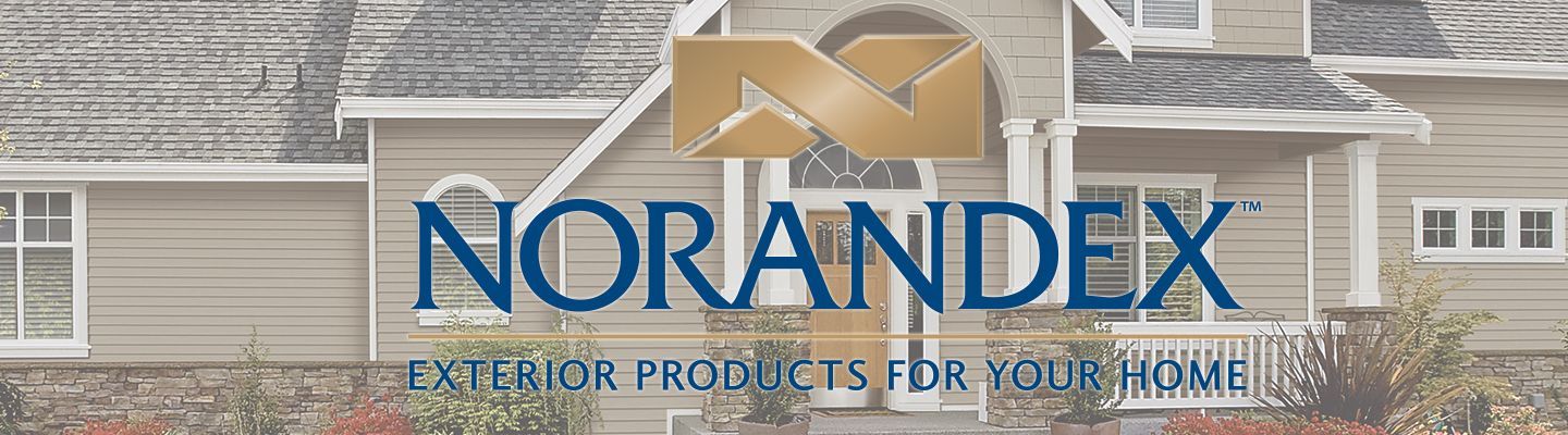 Norandex storefront sign with blue logo and tan awning on a brick building exterior