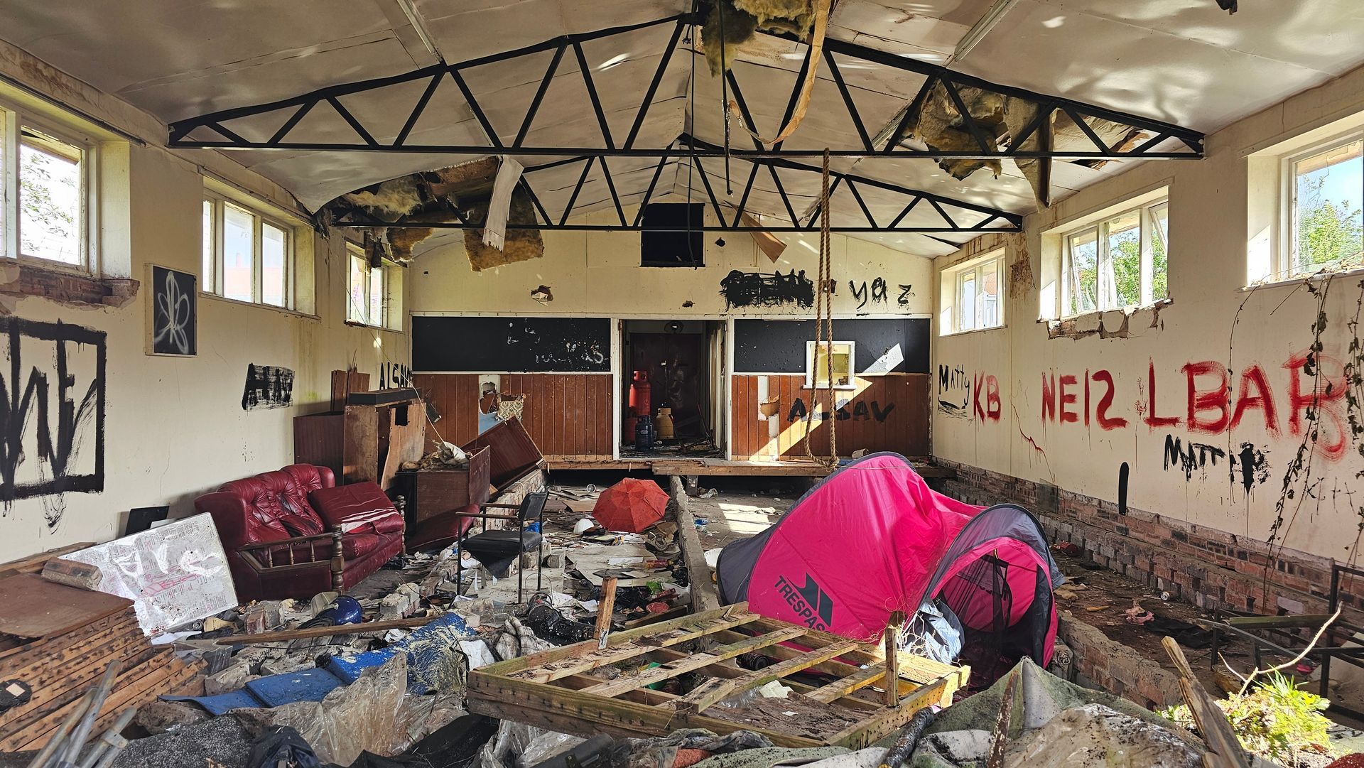 Internal view of the concreate pre-fab building, full of rubbish, debris and original fixtures and fittings, ready to be soft-stripped.