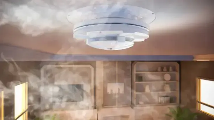 Smoke-filled room with a ceiling-mounted fire sprinkler and cabinets along the wall
