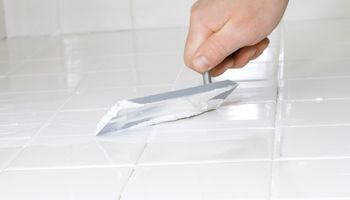 Putting tile grout on bathroom foor