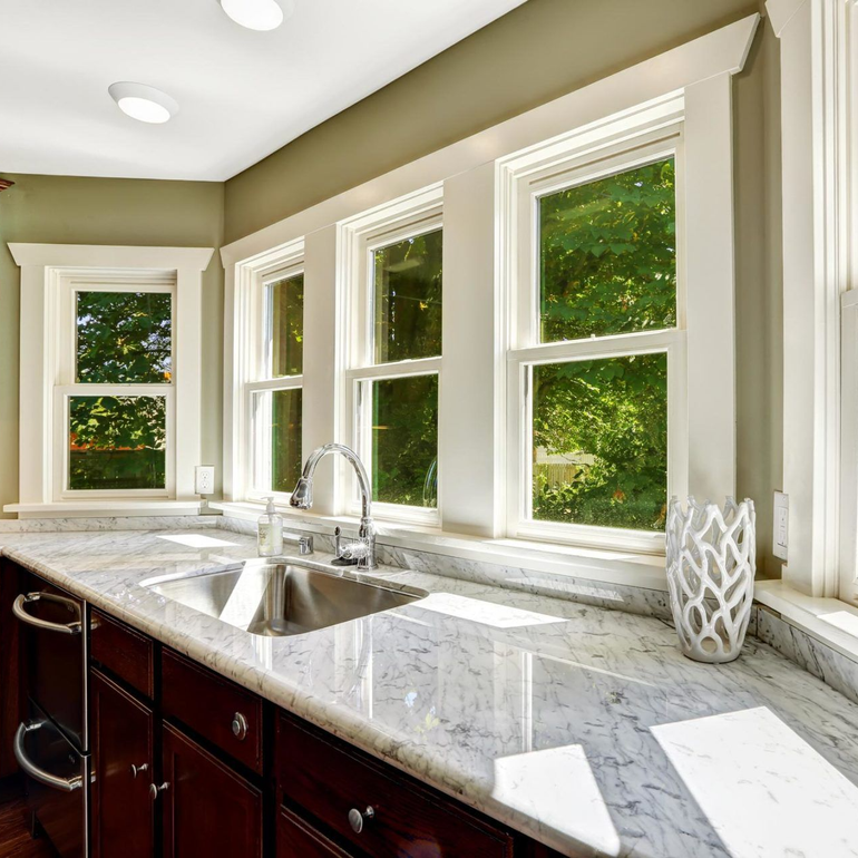 A kitchen with a sink and a vase on the counter
