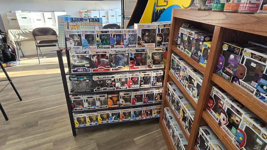 Toy store aisle with shelves of small boxed collectibles and figures on both sides