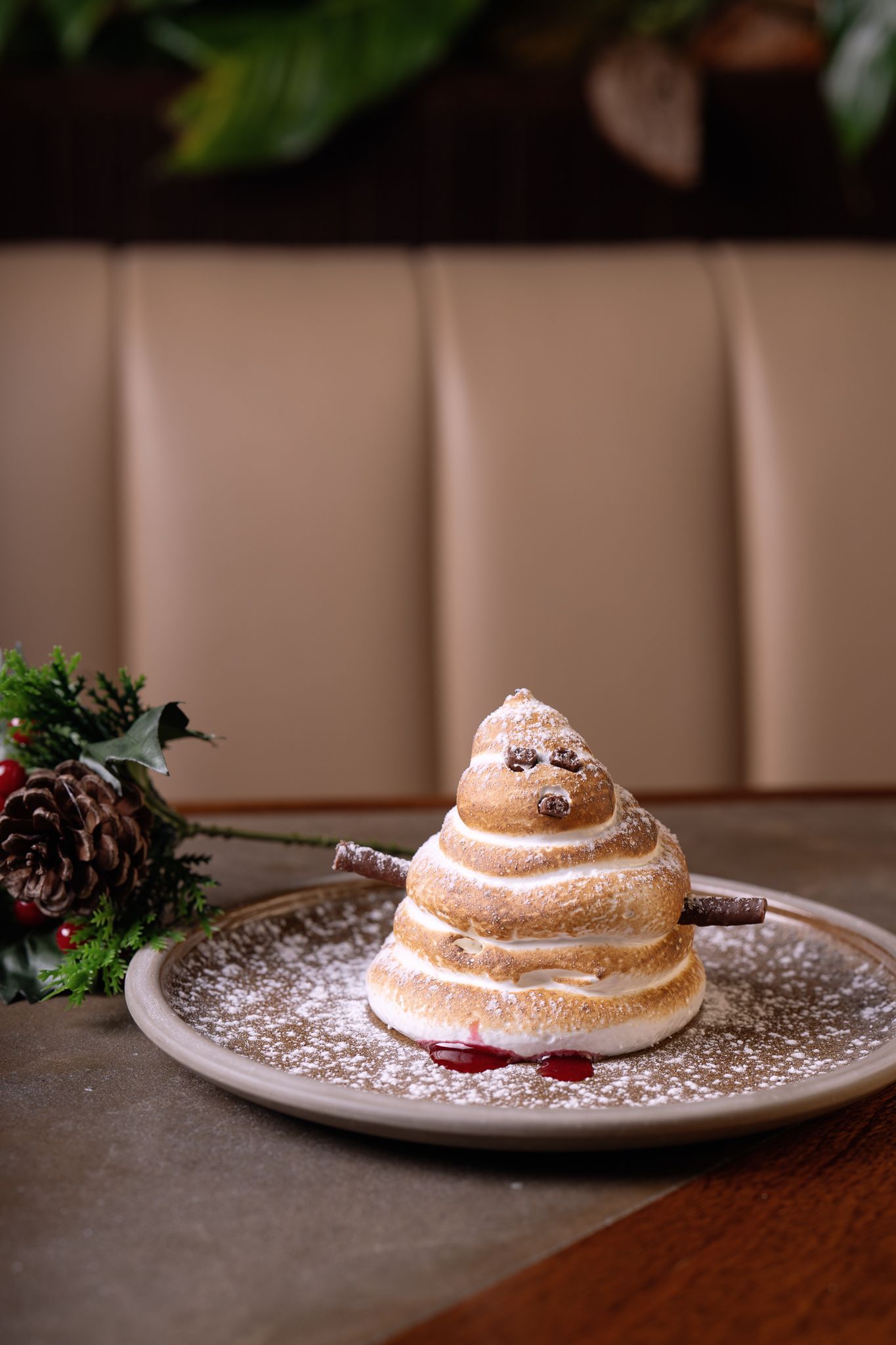 Powdered dessert on a plate in a cozy restaurant setting