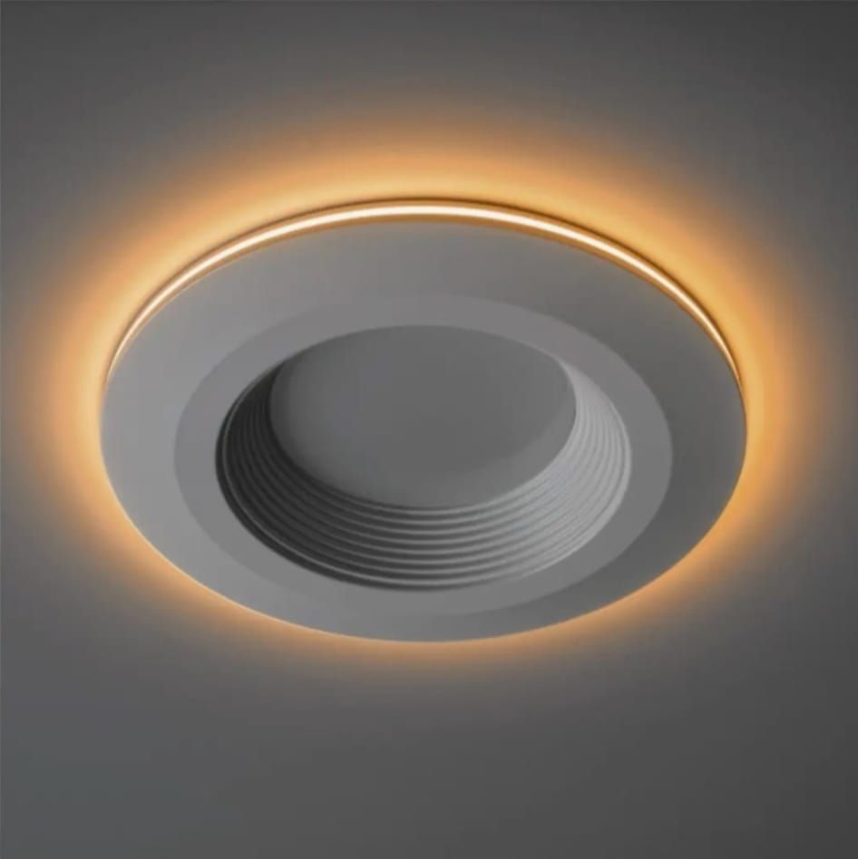 A black ceiling fan with spinning blades mounted to wooden ceiling beams near a skylight.