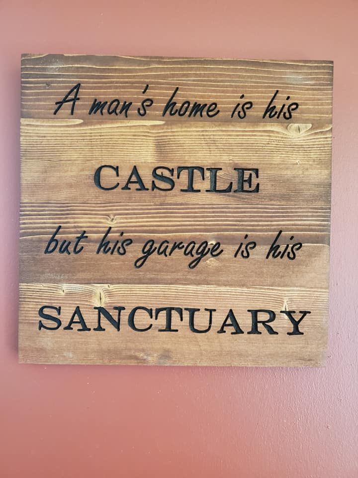 Wooden sign with dark lettering reads,