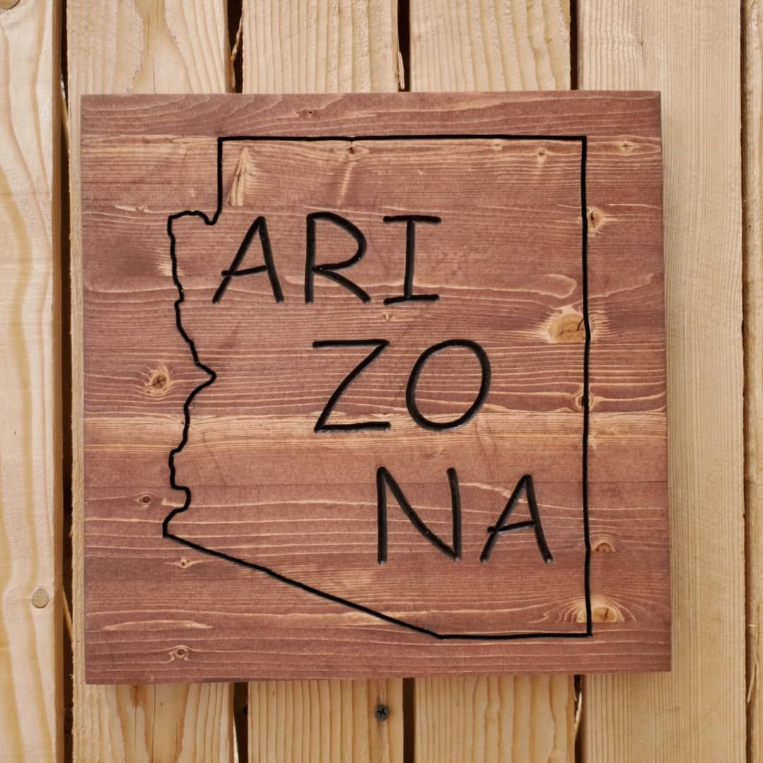 Wooden sign with the outline of Arizona, text