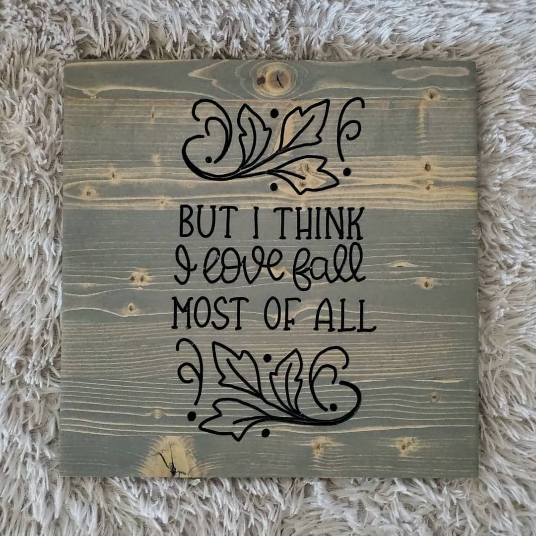 Wooden sign, gray-stained, with black lettering
