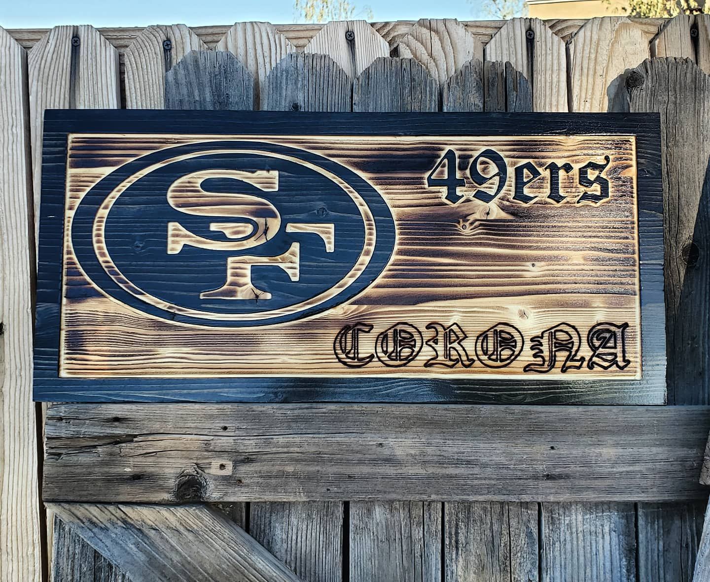 Wooden sign with a 49ers logo and the word