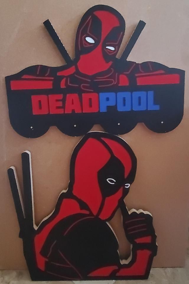 Two Deadpool cutouts: one with logo, the other posed with finger to chin. Red and black, wooden.